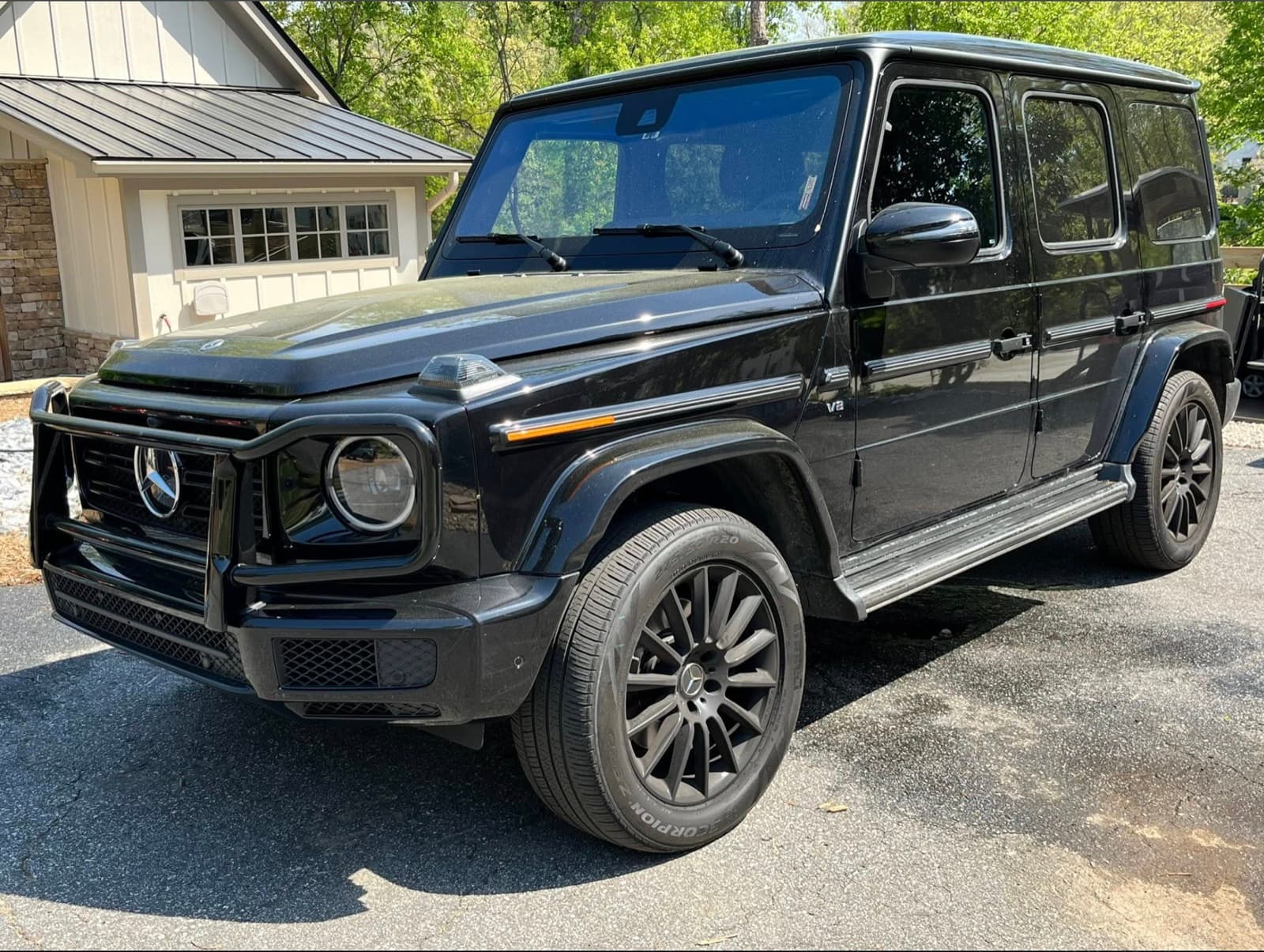 Freshly detailed black Mercedes-Benz G-Wagon in a Stilwell driveway after a signature exterior service.